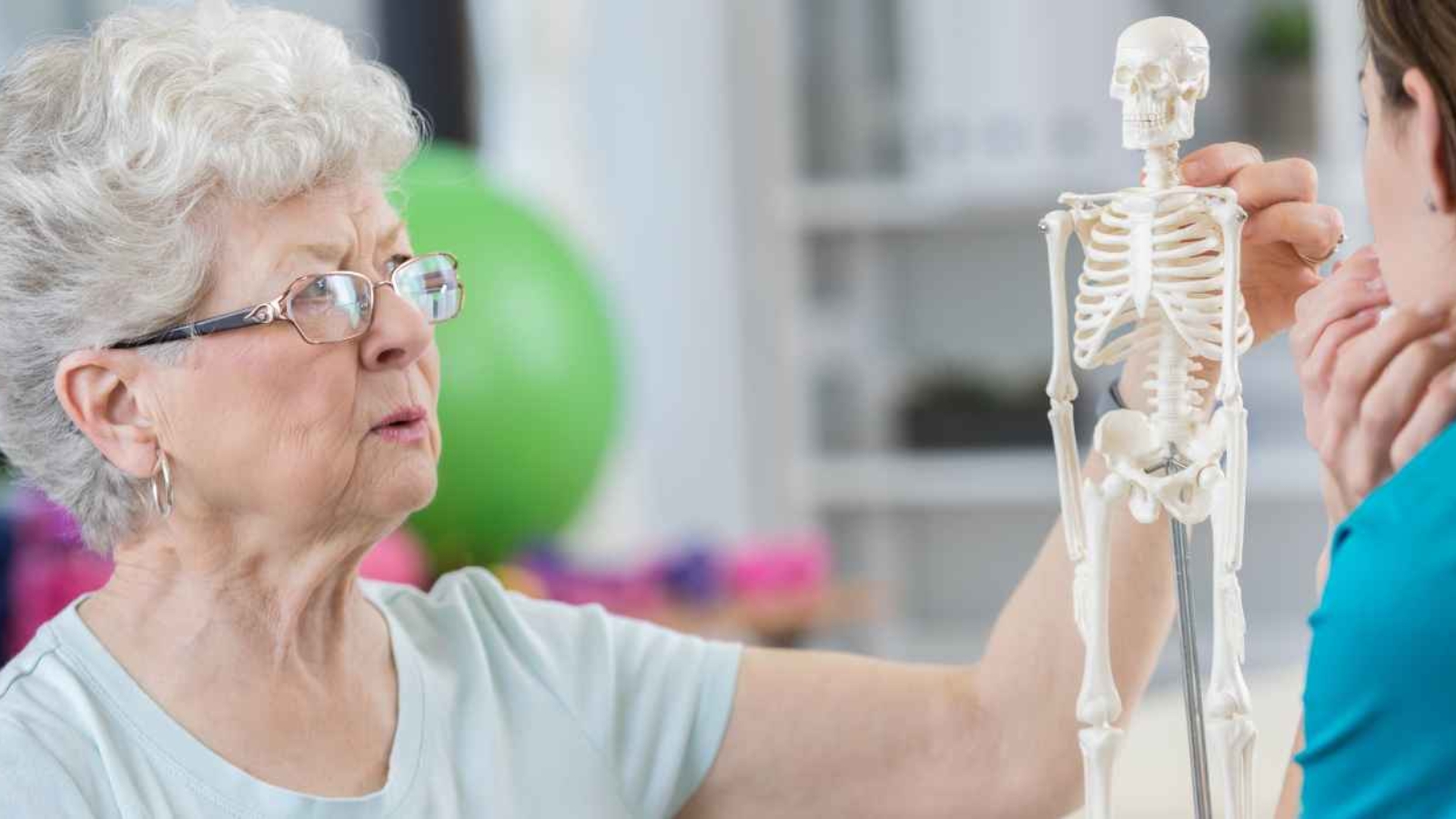 senior-woman-discusses-osteoporosis-during-physical-therapy