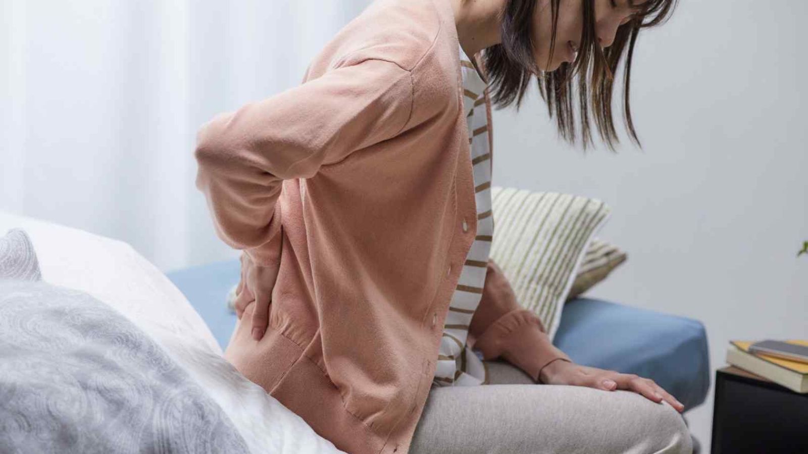 woman-experiencing-back-pain-at-home