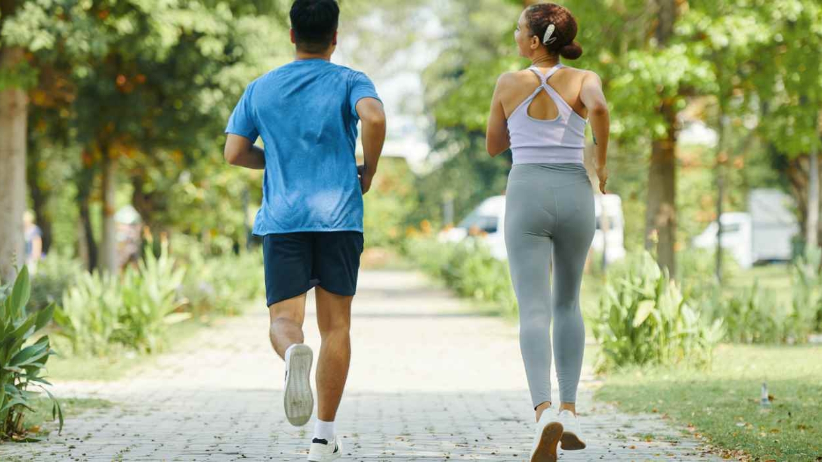 couple-jogging-together-along-a-park-path-during-a-sunny-day
